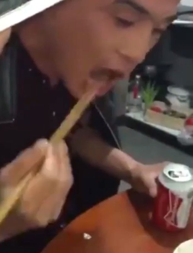 Man-swigs-back-a-beer-before-eating-live